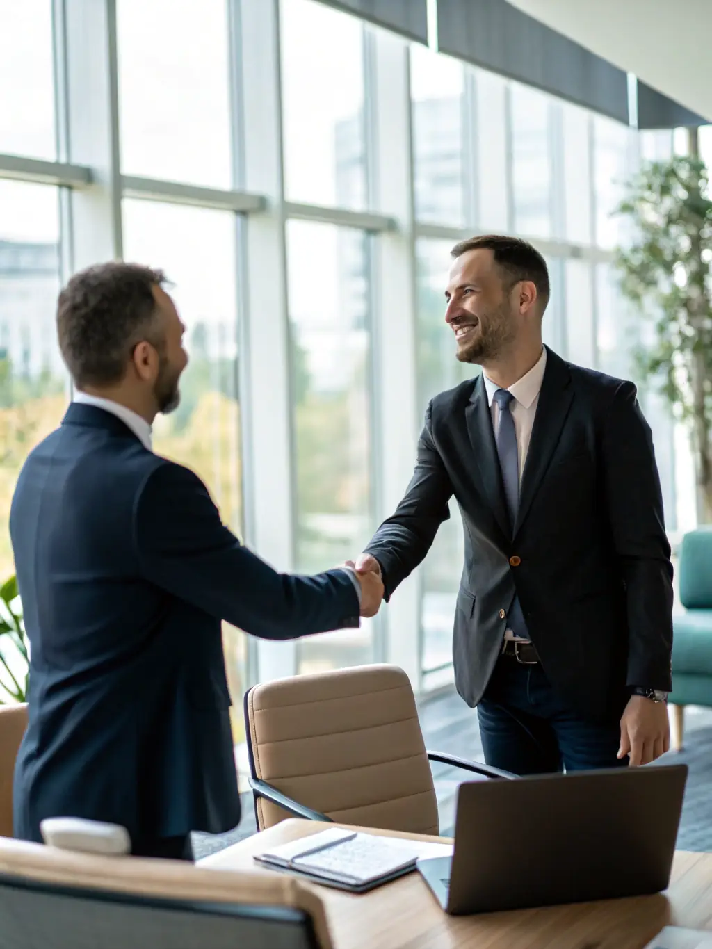 A close-up image of a handshake between a business owner and a financial consultant, symbolizing trust and partnership in achieving financial goals. The background is blurred to focus on the handshake.